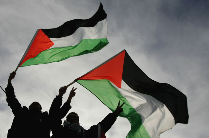 People wave flags for Palestine freedom